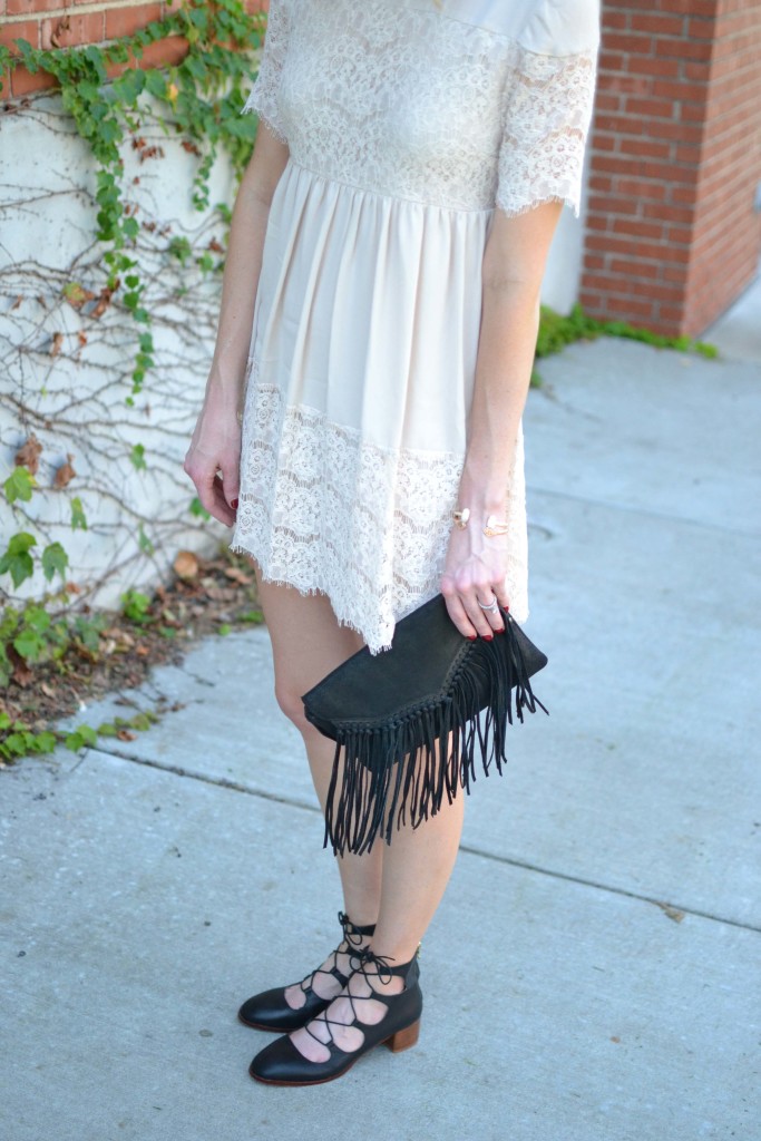 cream lace babydoll dress, black fringe bag, lace up shoes