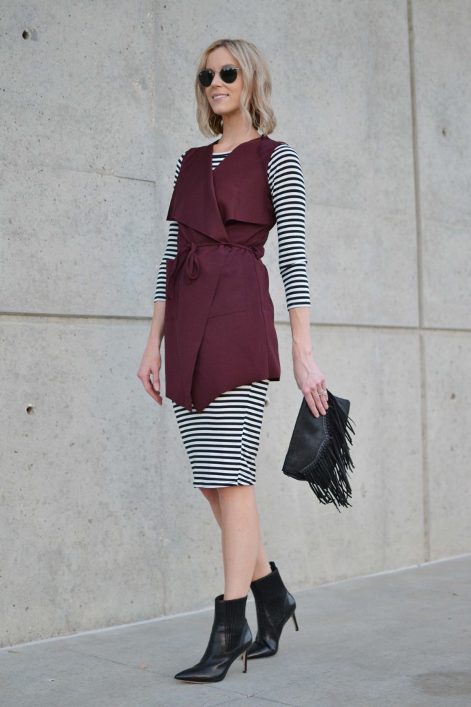 striped dress, burgundy vest, black boots, fringe bag