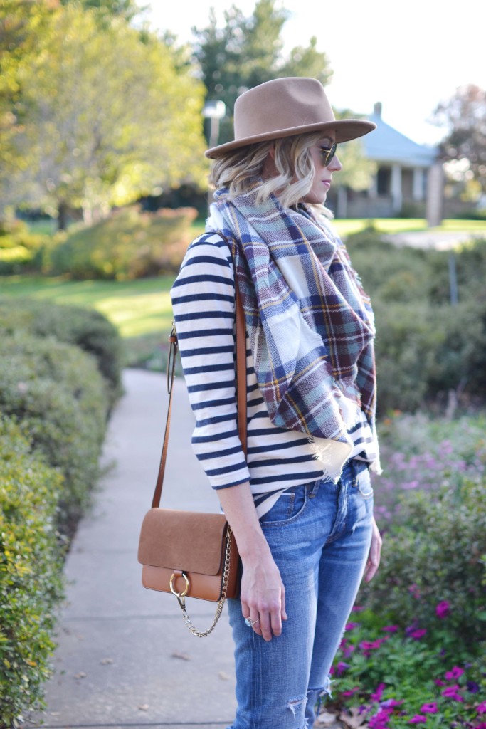 Striped top, plaid blanket scarf, tan hat, distressed jeans, chloe dupe bag