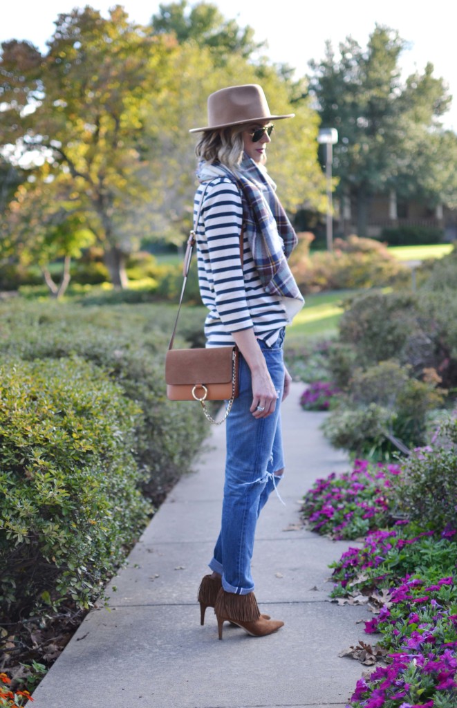 Striped top, plaid blanket scarf, tan hat, distressed jeans, chloe dupe bag, fringe booties