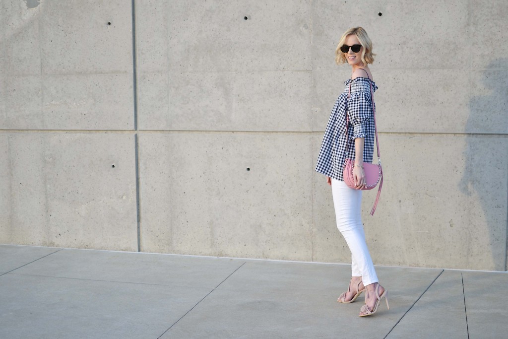 Today I'm styling pieces from the new Kendra Scott summer collection with a gingham off the shoulder top, white jeans, and the cutest pink bag.