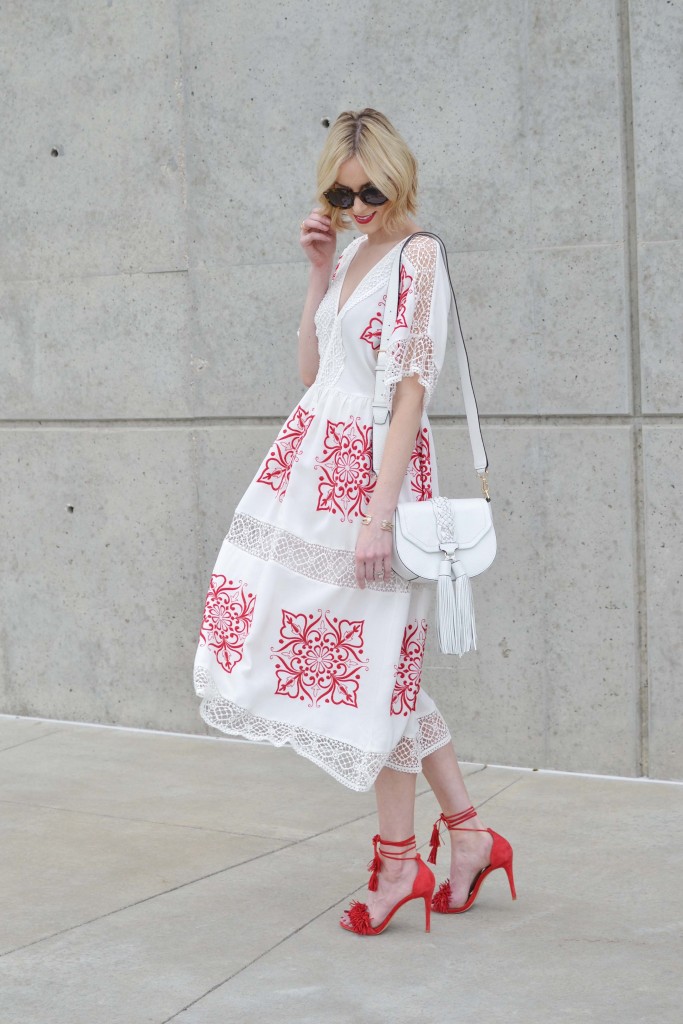 red and white embroidered midi dress, red lace up heels, white tassel purse