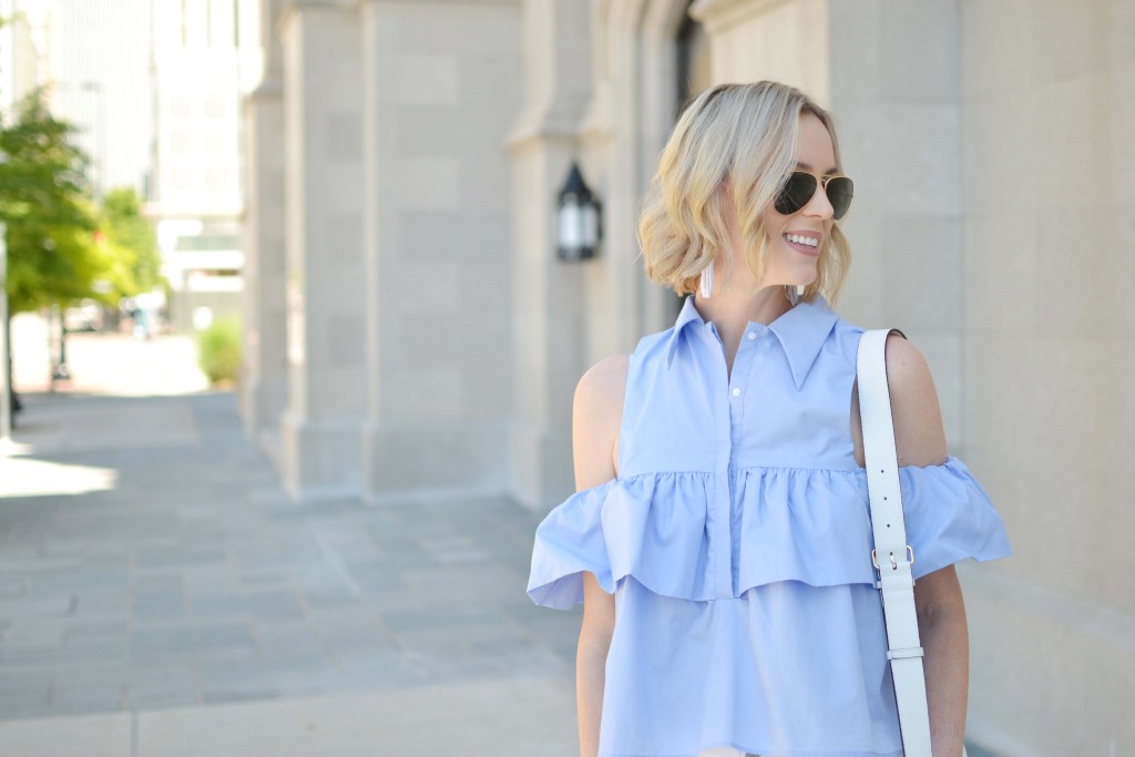 blue ruffle cold shoulder top, white jeans, white bag, open toe heeled booties