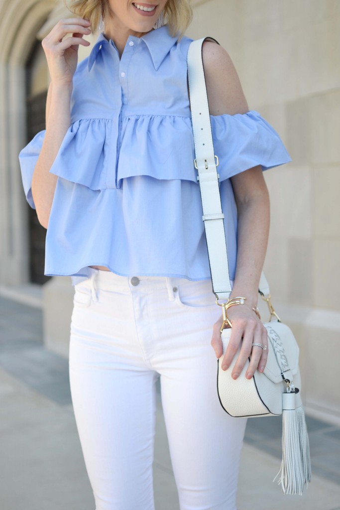 blue ruffle cold shoulder top, white jeans, white bag, open toe heeled booties