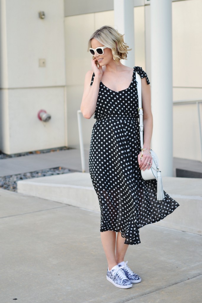 how to wear the sneaker trend, floral Nike sneakers, polka dot dress, white tassel bag, black and white