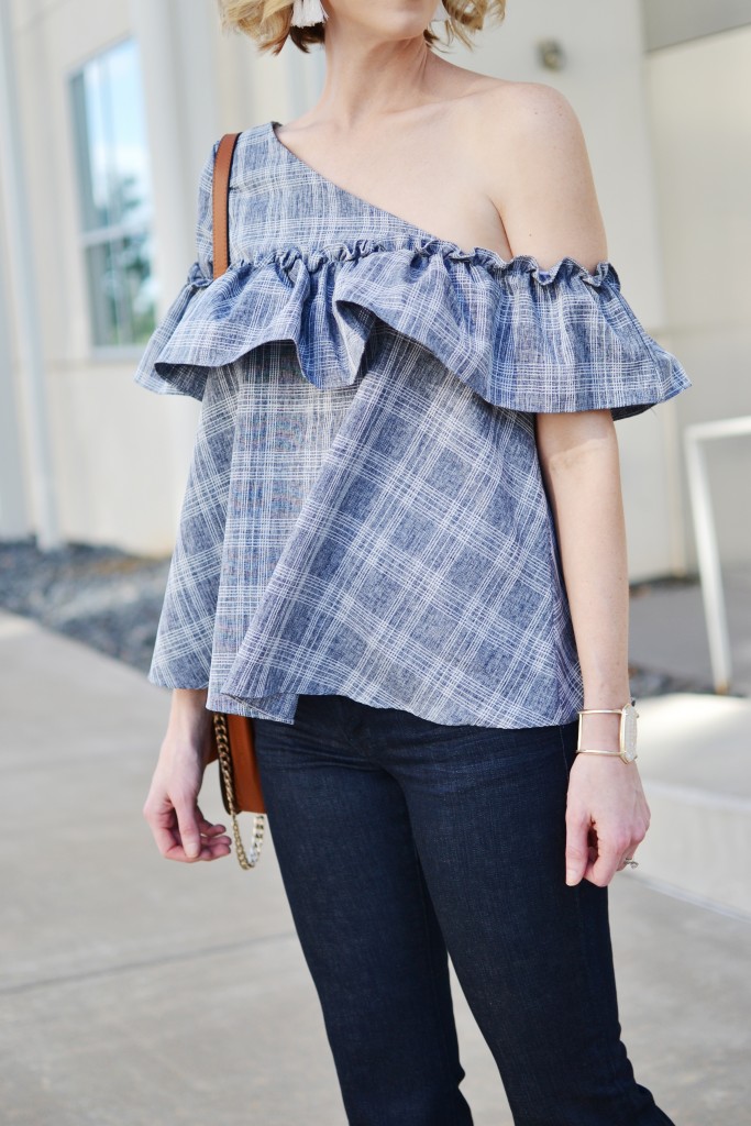 one shoulder ruffle top with flare jeans