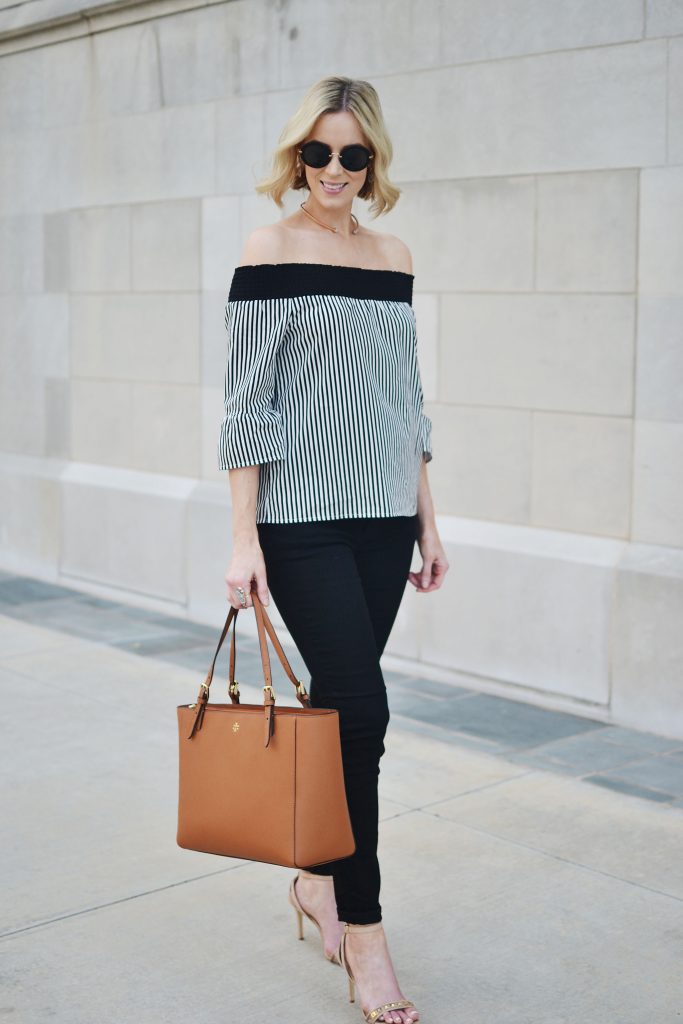 black and white striped OTS top, black jeans, tan Tory Burch tote