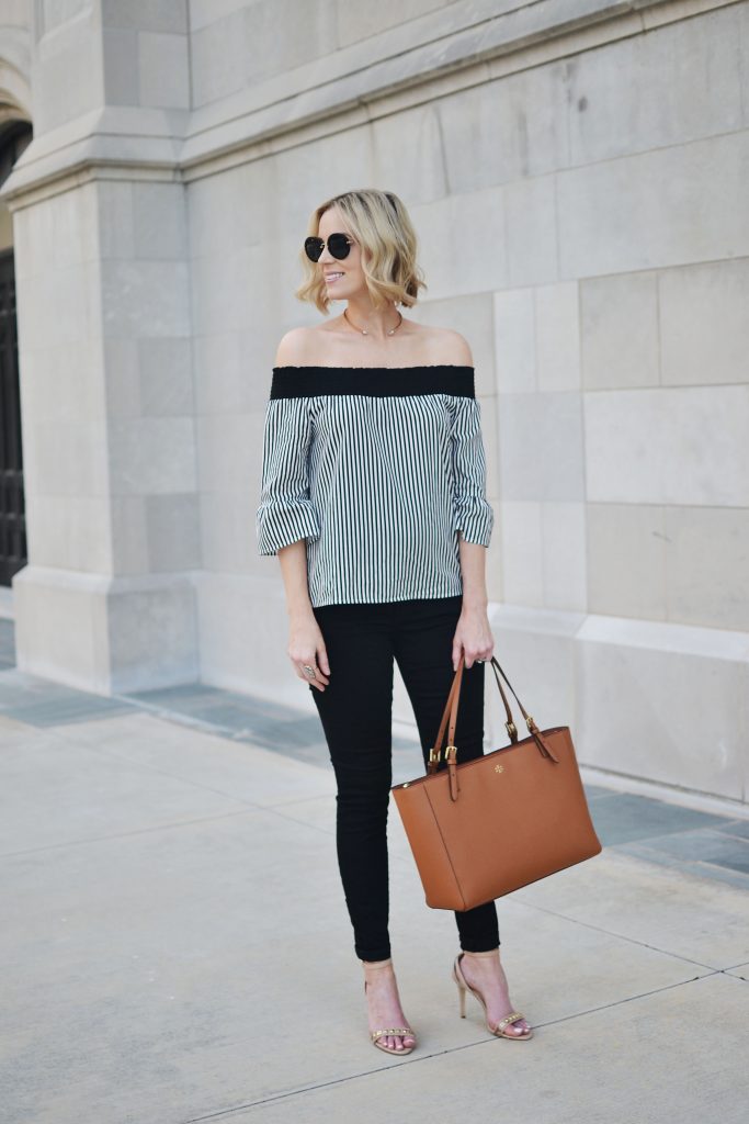 black and white striped OTS top, black jeans, tan Tory Burch tote