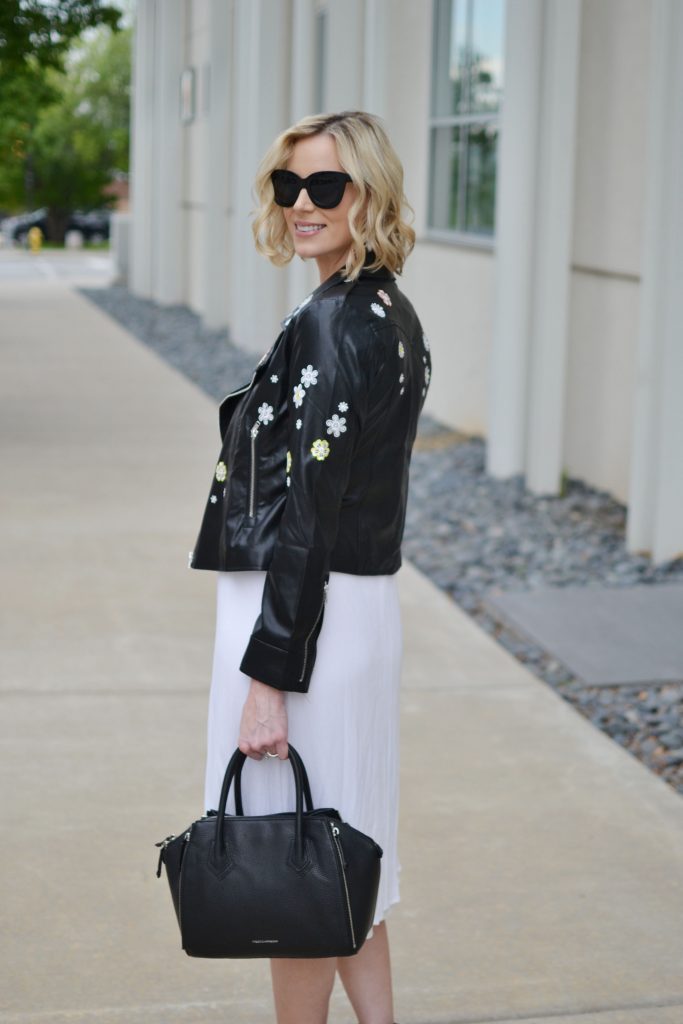 white midi dress, embroidered leather jacket, black bag, black heeled ankle booties, stylish maternity outfit