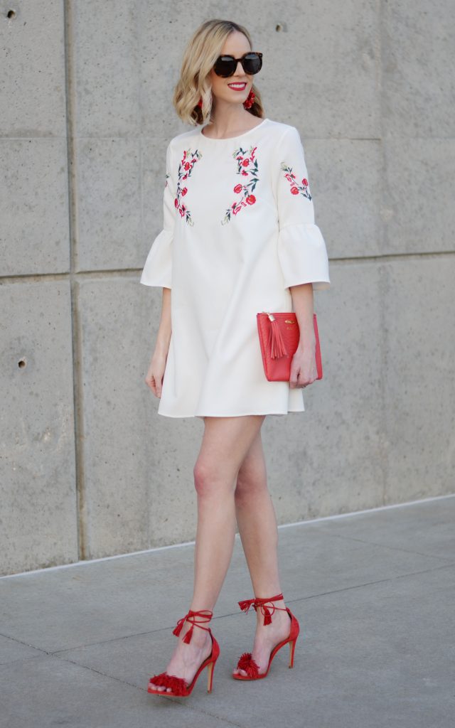 how to stay stylish on a budget, embroidered white dress, red tassel heels, red clutch