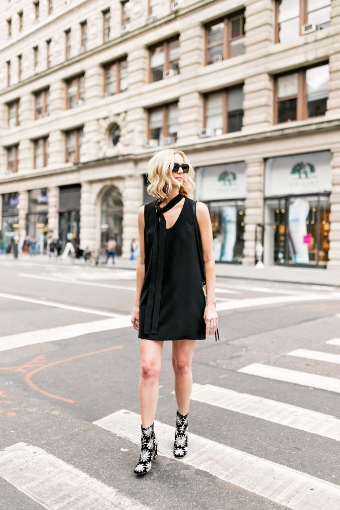 new york fashion week street style fashion photo, black dress with tie neck, black boots with silver flowers