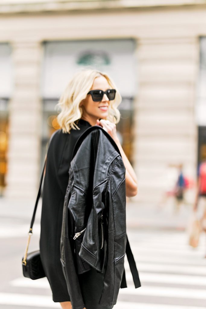 black mini dress with black leather moto jacket, all black outfit