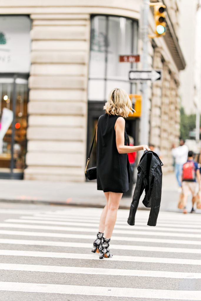 new york street style photo, what to wear to NYFW, black dress and boots with moto jacket
