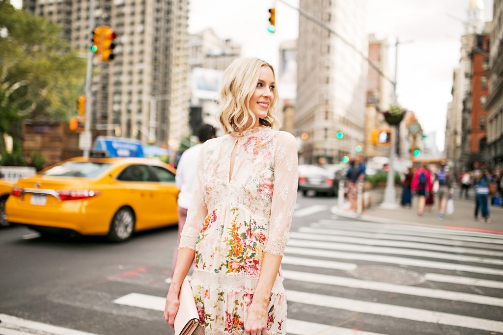 floral and lace feminine dress with blush clutch, new york street style photo