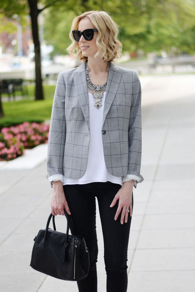 modern way to style a grey blazer, white layered cami, black coated skinny jeans, silver necklace