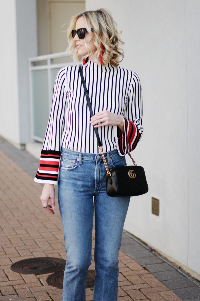mom style straight leg jeans with striped bell sleeve top, black sunglasses and black gucci marmont bag