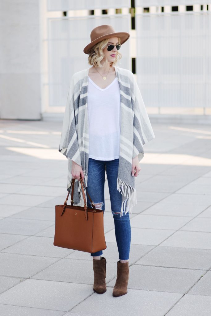 how to style a poncho with jeans, casual poncho outfit styling, distressed denim, booties, hat