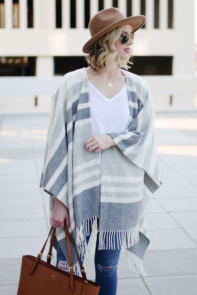 grey neutral poncho with white tee shirt and hat