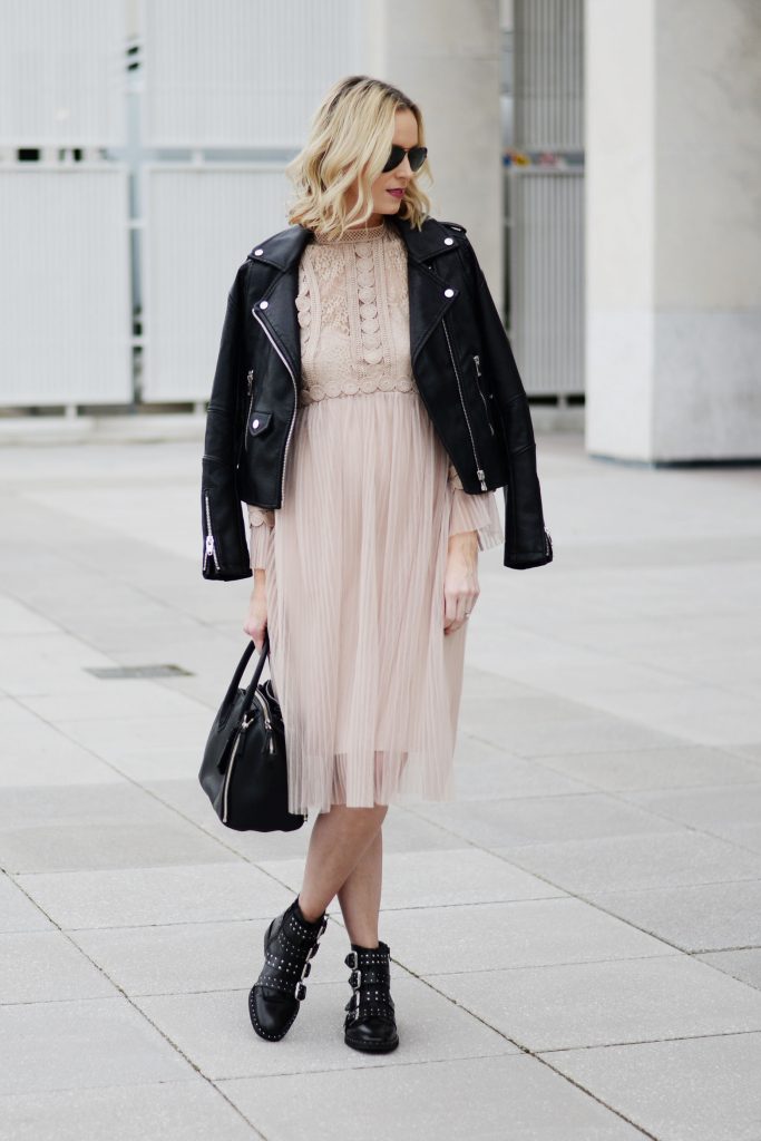 nude tulle dress with black leather jacket and black boots