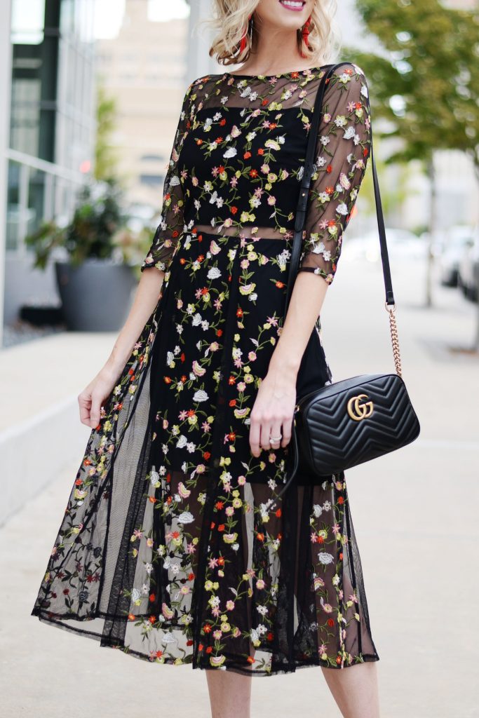 beautiful dark floral embroidery overlay midi dress with sheer paneling and black gucci marmont bag