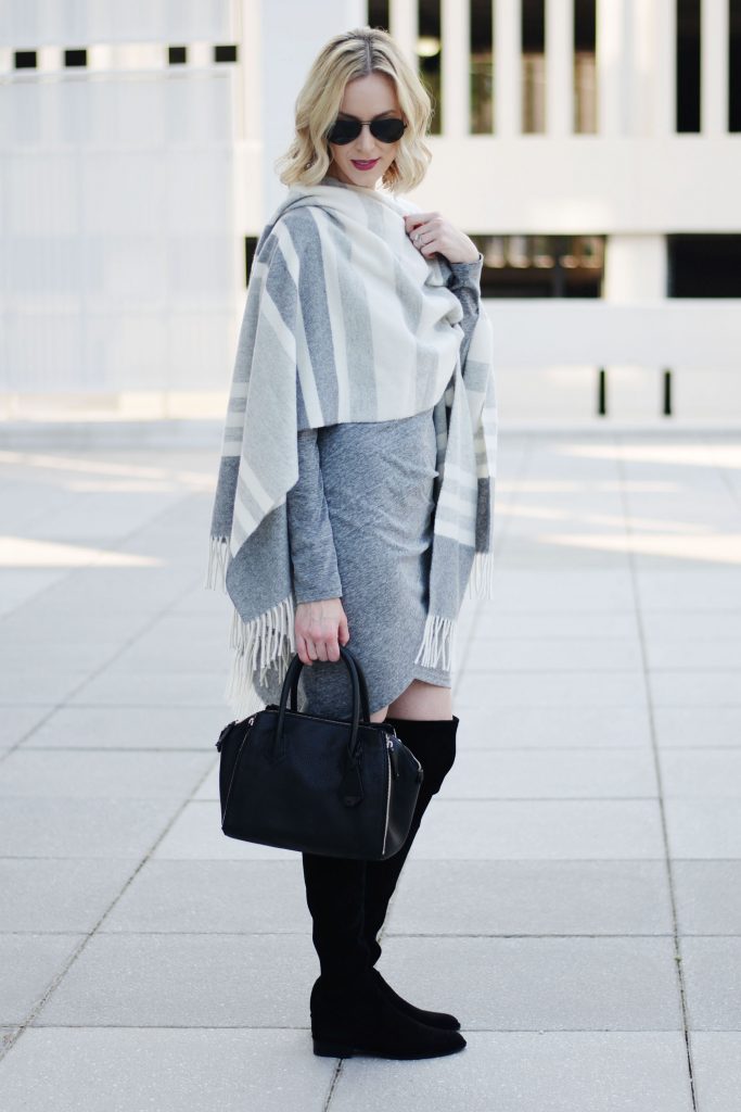 how to style a poncho with a dress, grey ruched dress with black over the knee boots and grey striped poncho worn as a wrap, how to wear a poncho