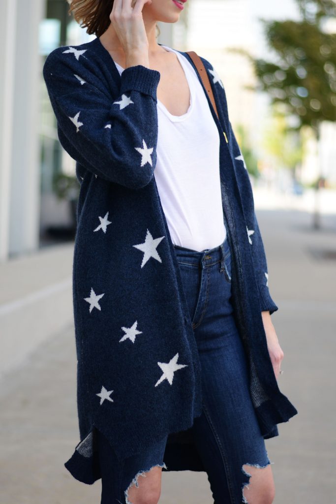 blue and white star cardigan with white t-shirt tucked into jeans