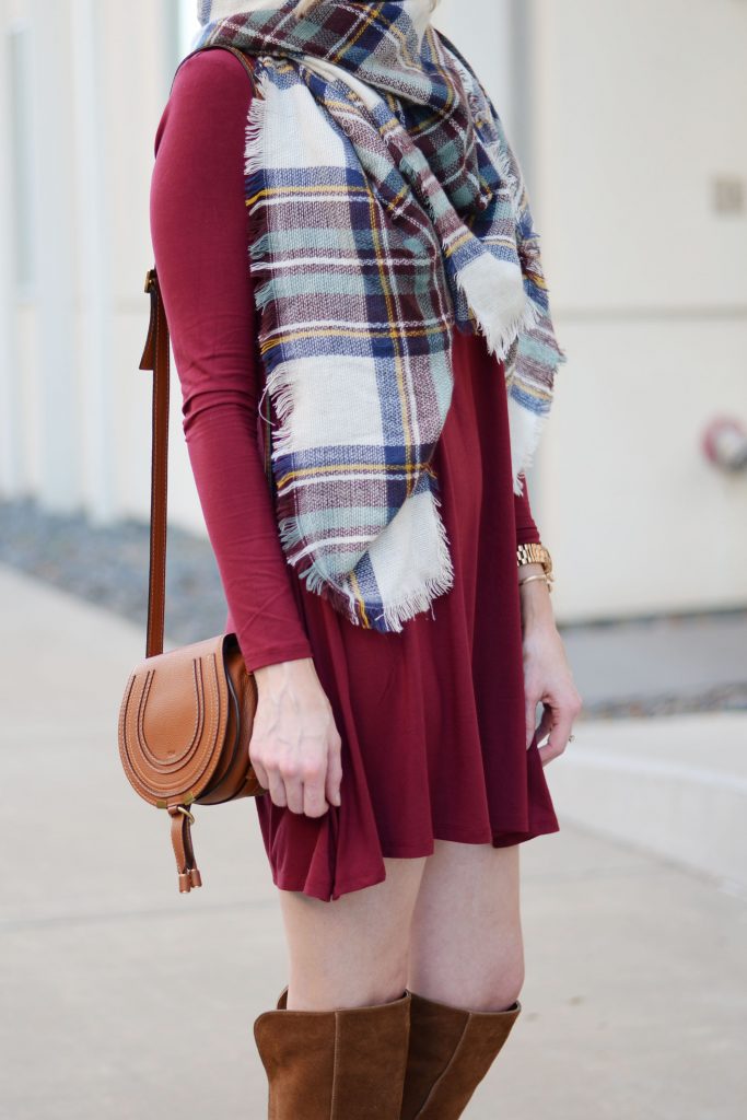 burgundy dress with cognac boots and bag styled with plaid scarf