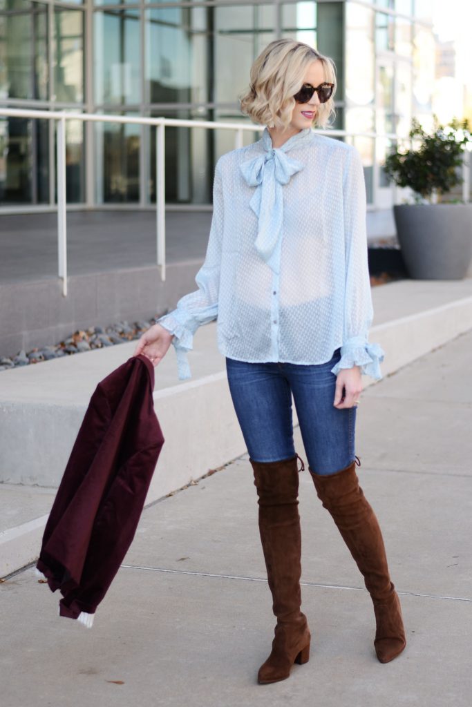 sheer baby blue dot tie front blouse with jeans and over the knee boots