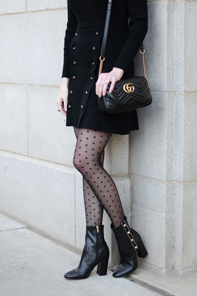 black sweater dress with gold buttons, polka dot tights, black boots with gold buttons, black gucci marmont bag