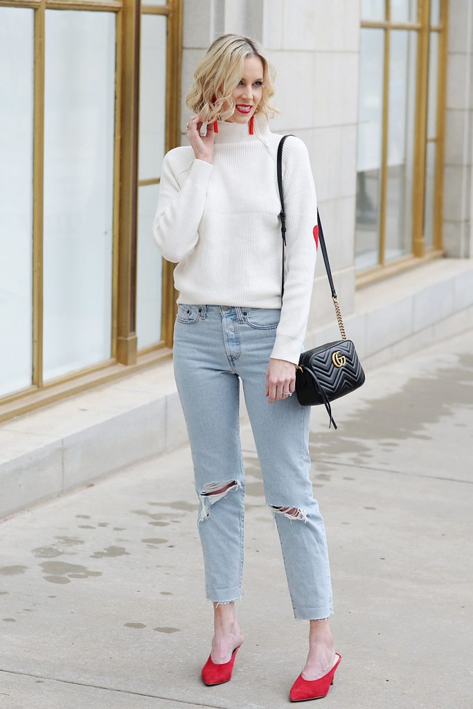 white sweater with red accents, light wash straight cropped jeans, gucci bag