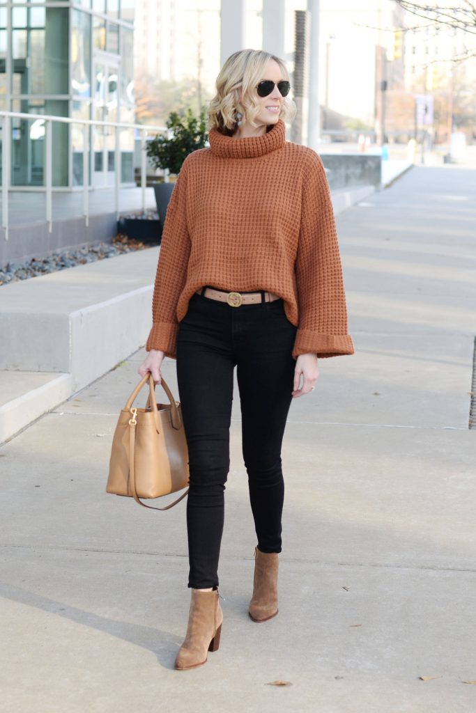 black jeans with tan sweater and accents, black and brown outfit