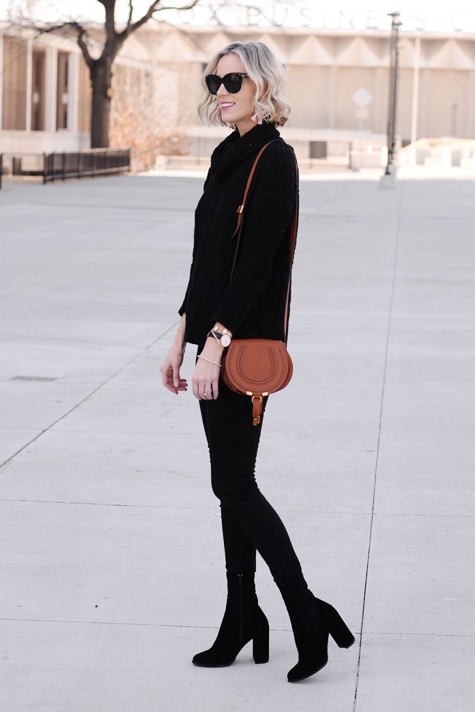 all black outfit with tan bag, add sock booties to make a long, lean leg line