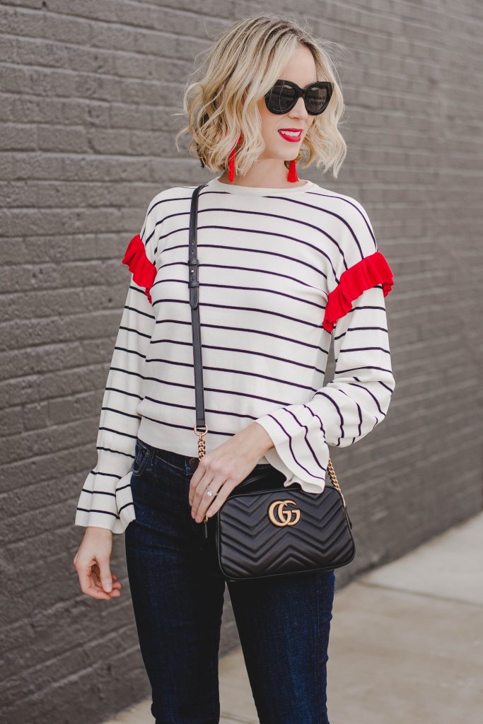 red ruffle top with red lipstick and red earrings, gucci bag