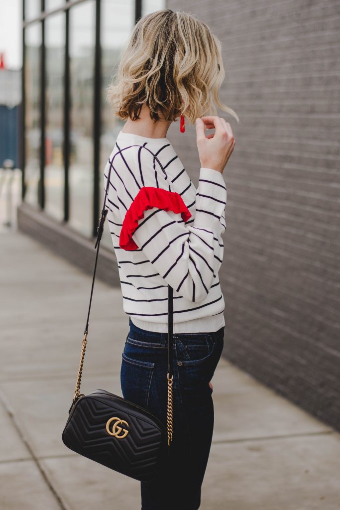wavy long bob, blonde hair, wavy hair, black and white striped top with red ruffle, gucci bag