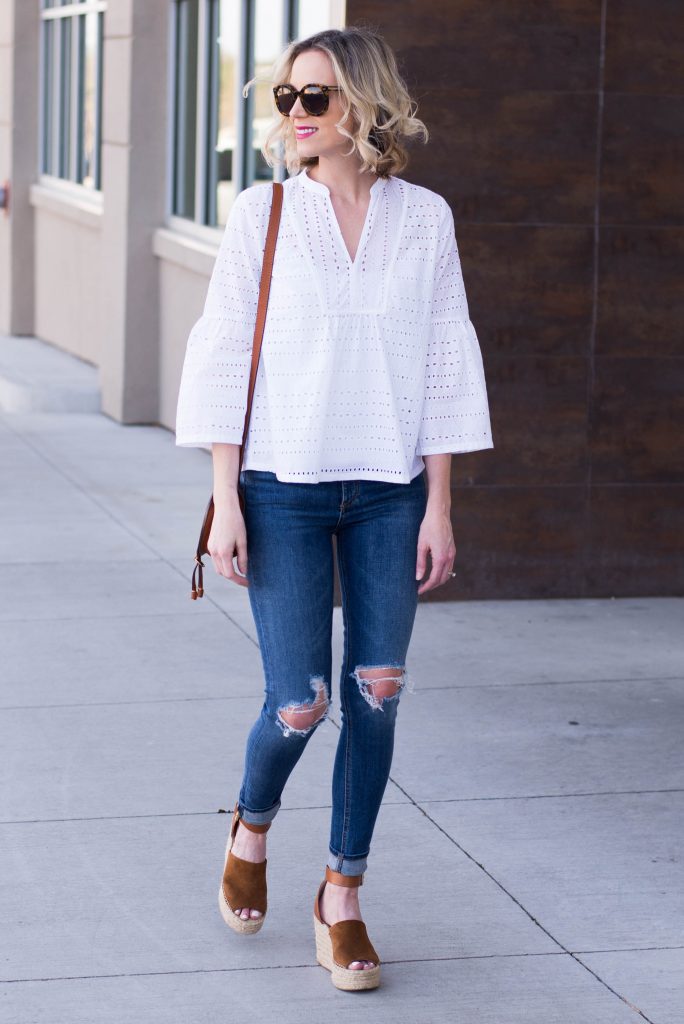 white eyelet top with jeans and cognac wedges and bag