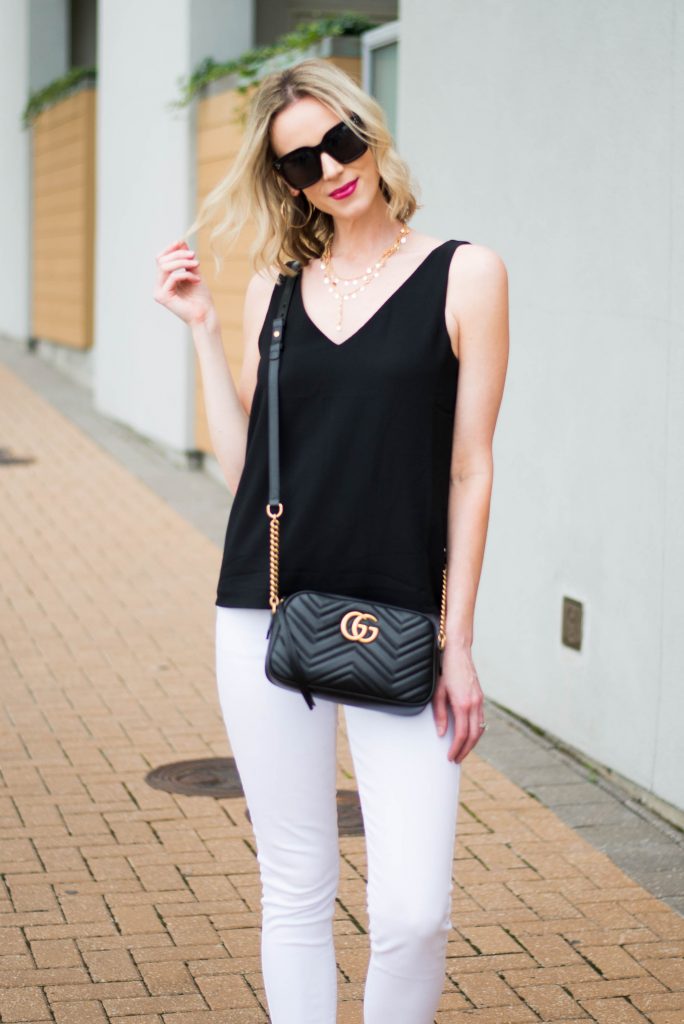 black tank with gold accessories and black gucci bag