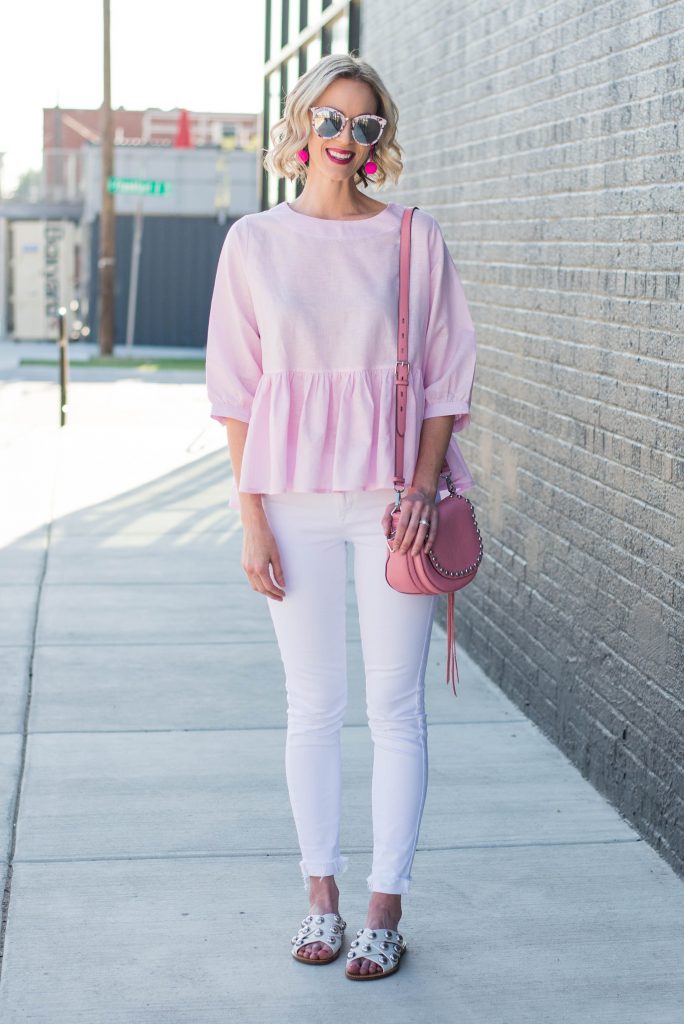 pink peplum top with white jeans and pink accessories