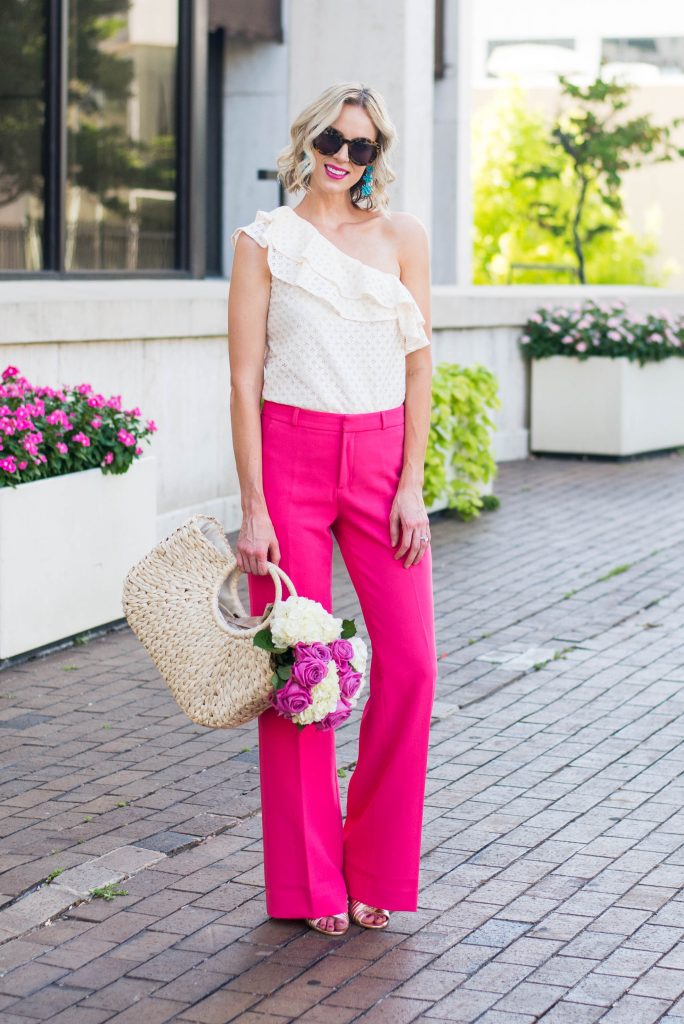dressy pink pants with one shoulder cream ruffle top