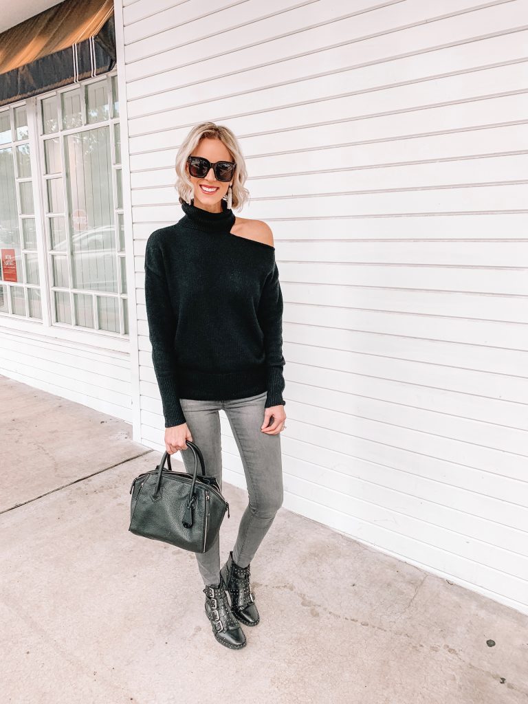 black cutout sweater and grey jeans