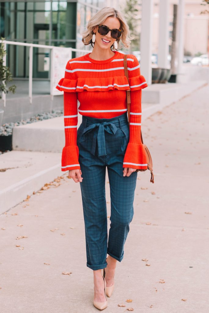 navy paperbag waist pants with orange stripe ruffles sweater, cool work outfit idea
