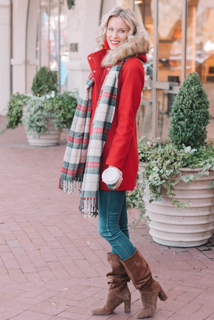 red coat with fur lined hood and plaid scarf