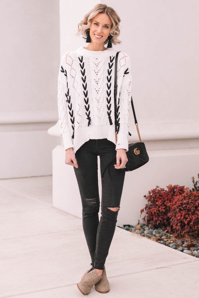 lace up sweater, white and black sweater with black skinny jeans and taupe boots