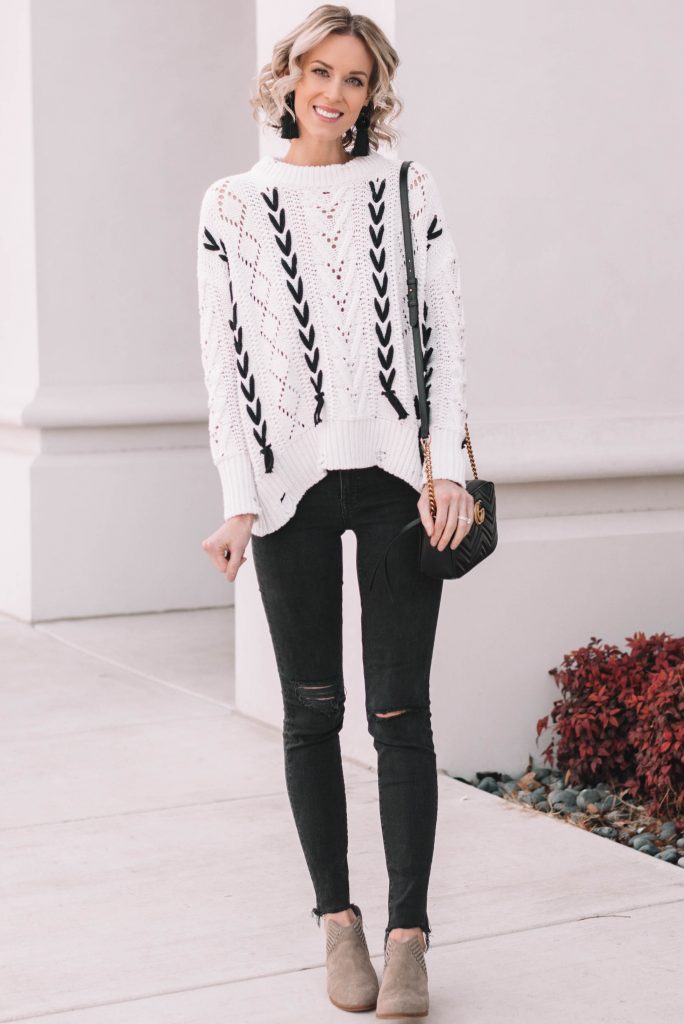 lace up sweater, white and black sweater with black skinny jeans and taupe boots