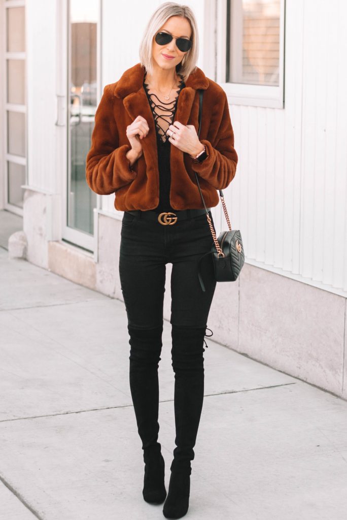 all black outfit, black jeans, black heeled over the knee boots, brown faux fur coat