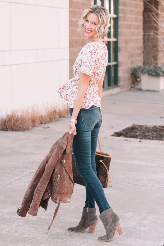 twist front floral blouse with skinny jeans and boots