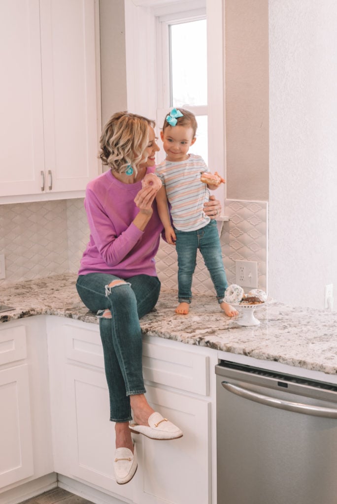 mother daughter sharing donuts