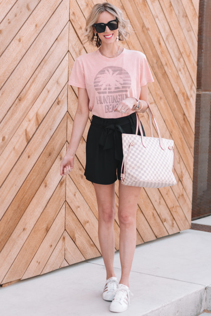 paperbag waist shorts styled casually with a t-shirt and sneakers