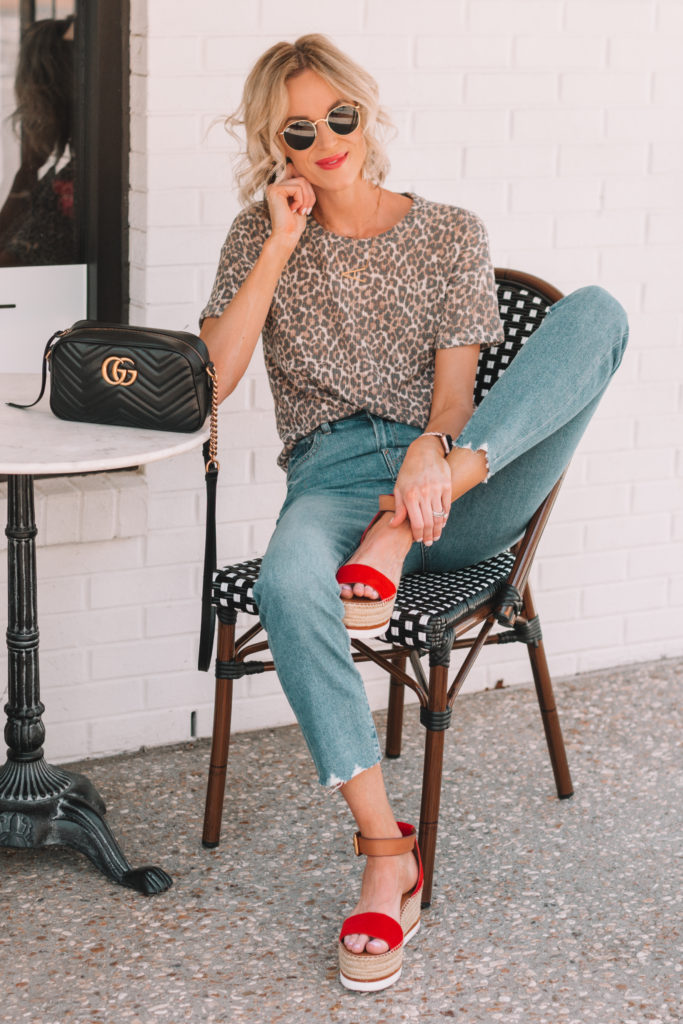 leopard shirt styled with mom jeans and red flatform sandals