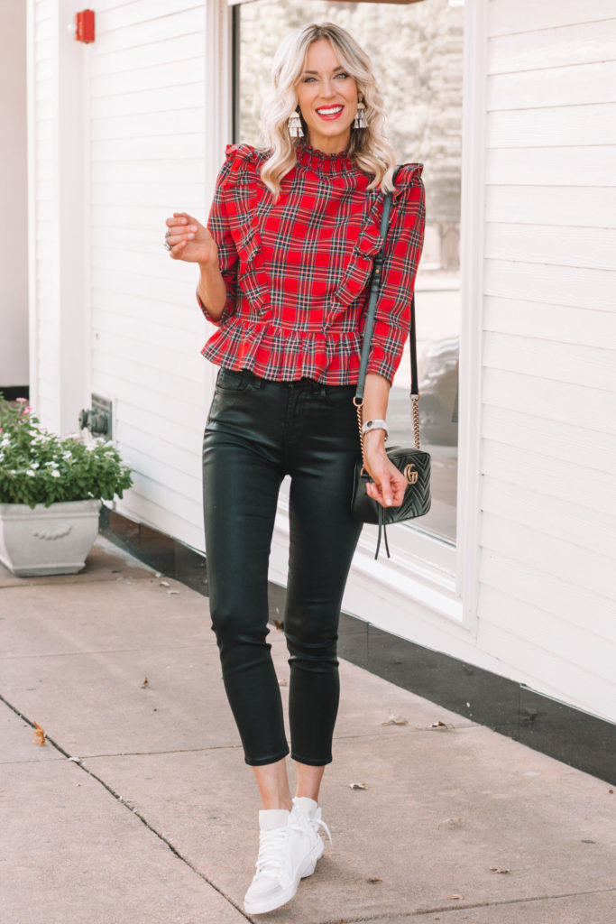 coated black jeans with red plaid top and golden good dupe sneakers