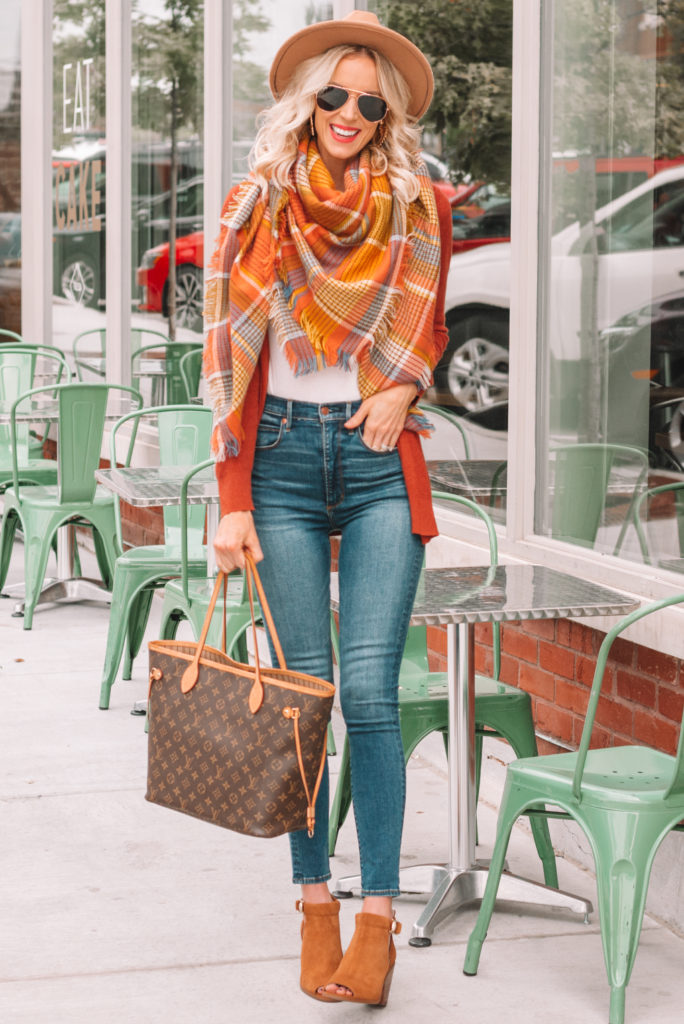 fall colored plaid blanket scarf with cardigan, jeans, and boots